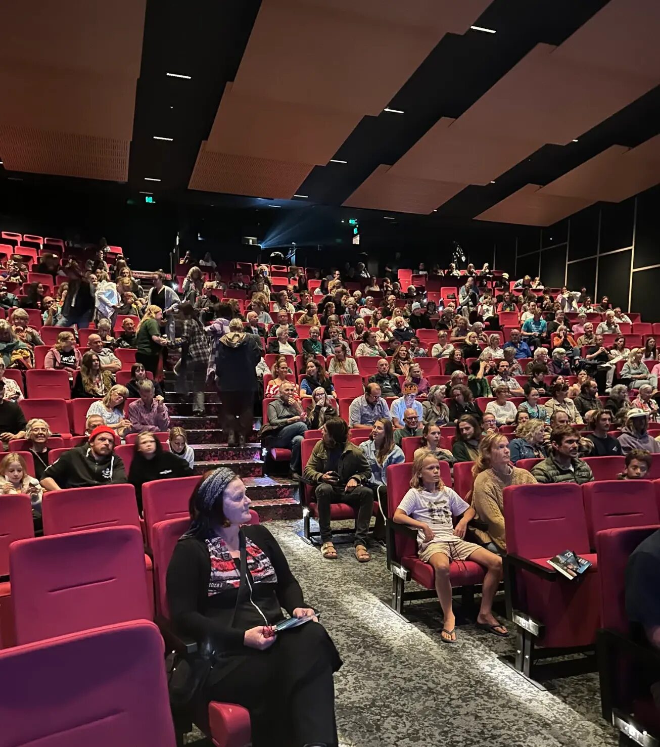 A full cinema audience waiting for a screening