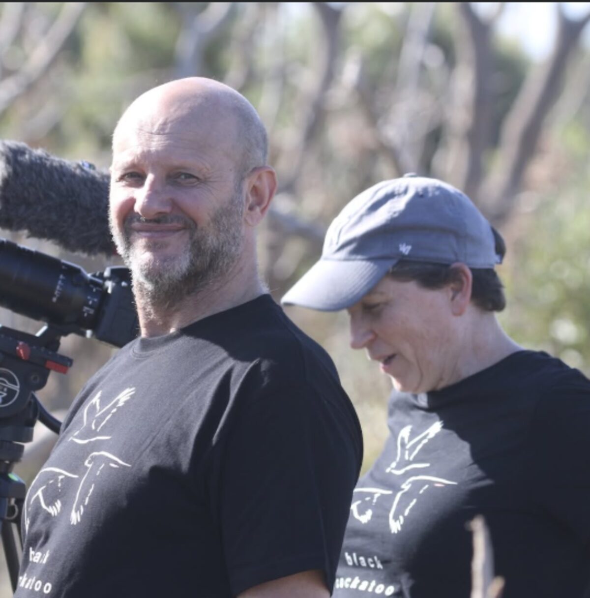 Filmmakers on location with a camera in the bush