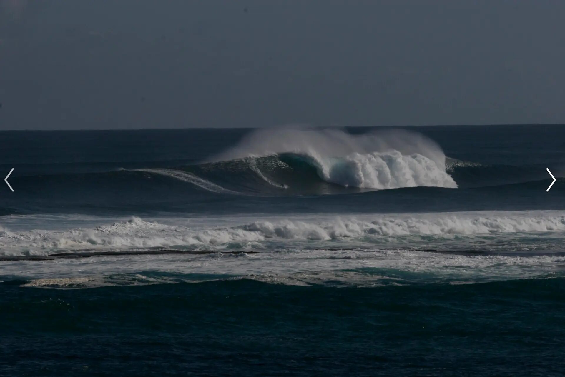 A surfer on a large wave off the coast